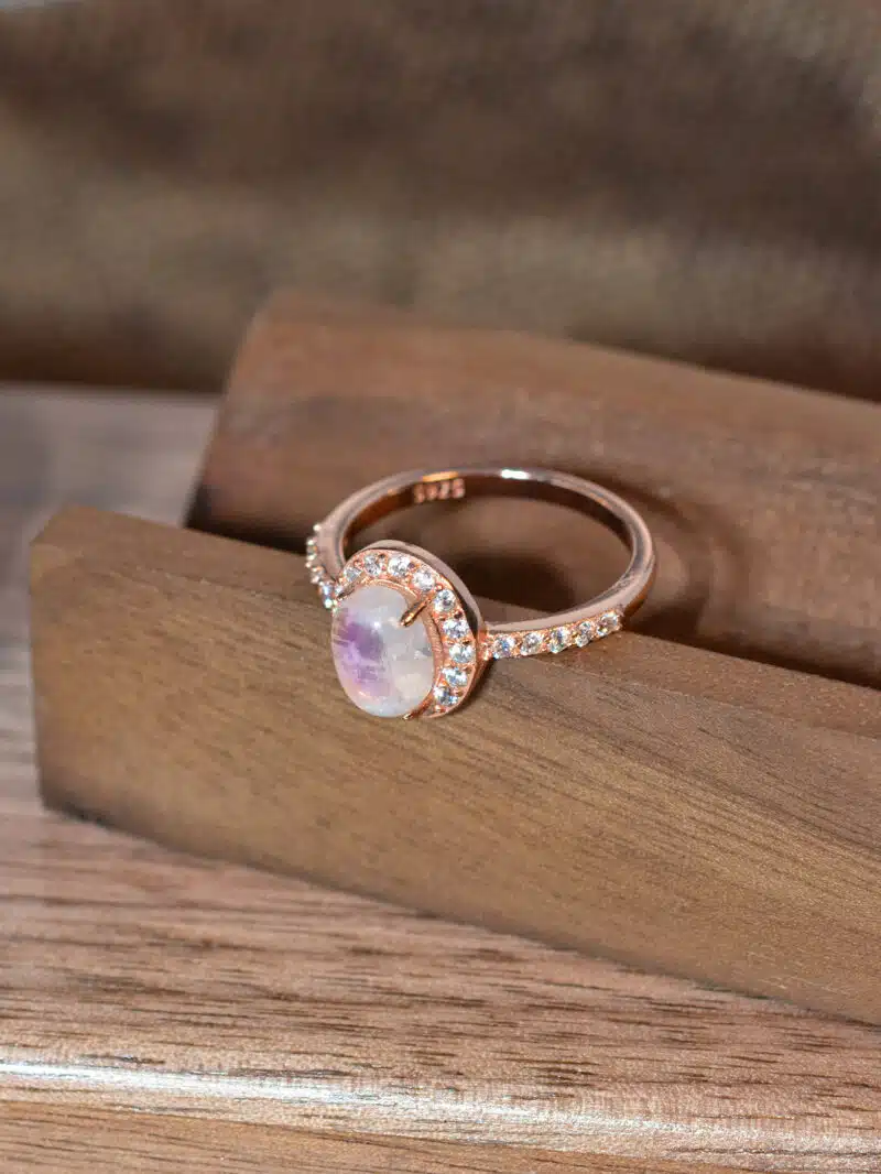 elegant moonstone ring worn on hand, featuring rose gold and crystal shimmer 1
