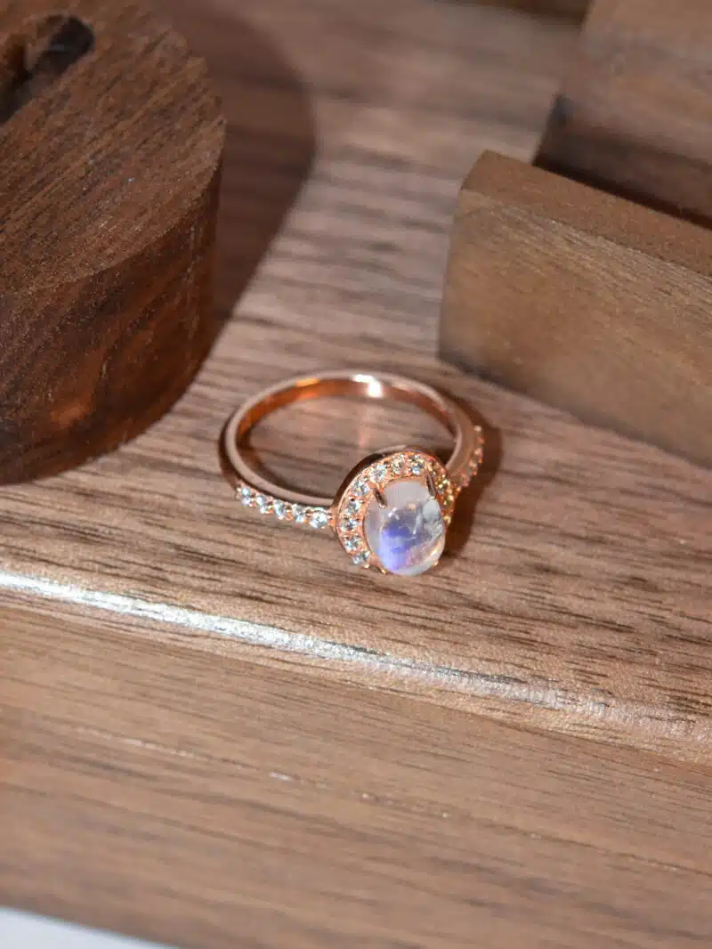 elegant moonstone ring worn on hand, featuring rose gold and crystal shimmer 3